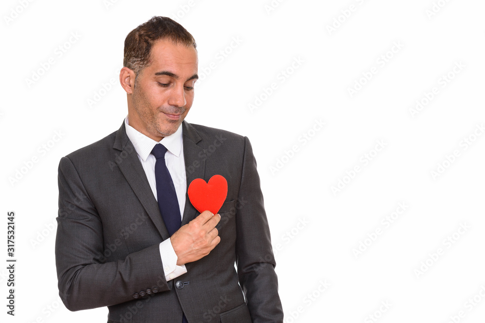 Mature Persian businessman holding heart ready for Valentine's day