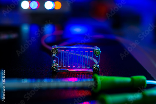 microfluidic device Instrument that uses micro amounts of fluid on a microchip to do certain laboratory tests. photo