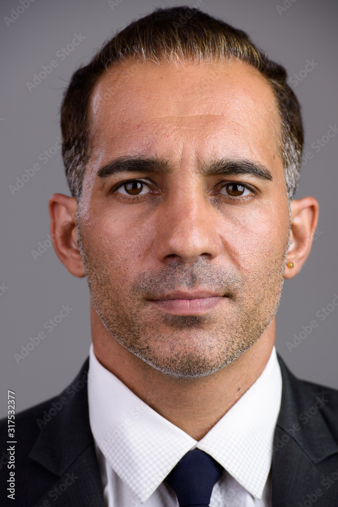 Face of mature handsome Persian businessman in suit Face of mature handsome Persian businessman in suit