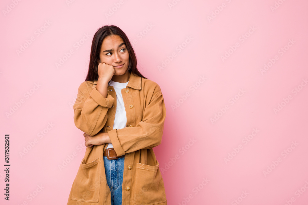 Young mixed race indian woman isolated who feels sad and pensive, looking at copy space. Young mixed race indian woman isolated who feels sad and pensive, looking at copy space.