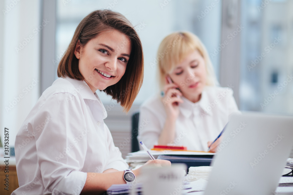 Two women in office working on a computer Two women in office working on a computer
