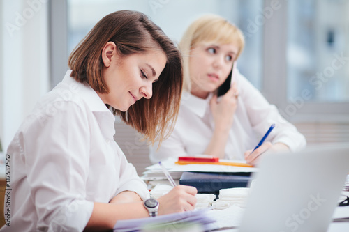 Two women in office working on a computer