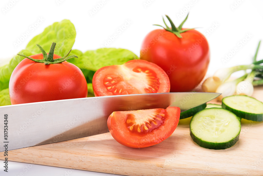 Concept of preparing a healthy salad - fresh and organic vegetables on a cutting board with a knife 