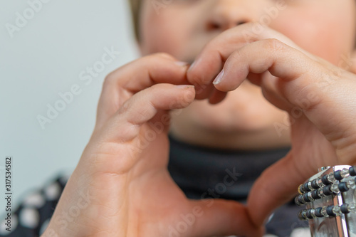 baby with heart shaped hands, isolated on White background photo
