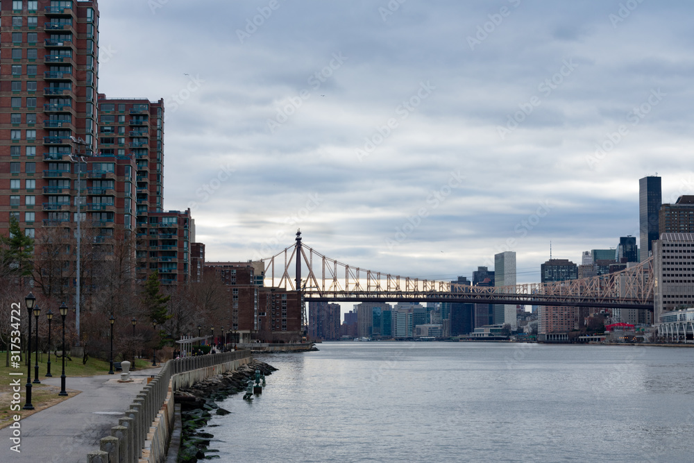 Waterfront at Roosevelt Island along the East River with the Queensboro Bridge connecting to Manhattan in New York City