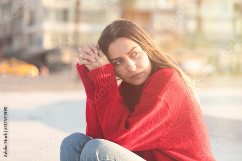 thoughtful and lonely woman sitting on bench on valentines day