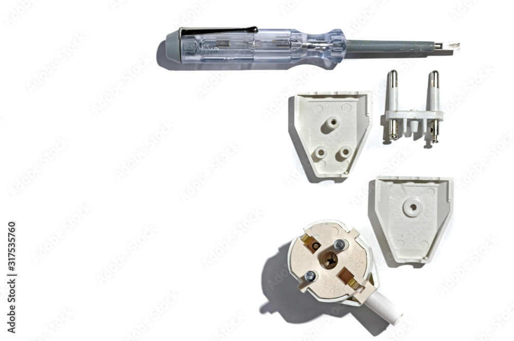 disassembling the electric plug using a screwdriver tester. on white background disassembling the electric plug using a screwdriver tester. on white background