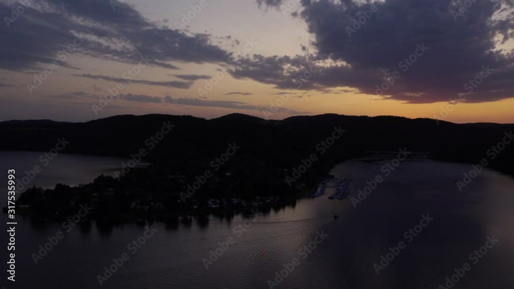 A time lapse of a sunset on a lake surrounded by nature and mountains. A time lapse of a sunset on a lake surrounded by nature and mountains.