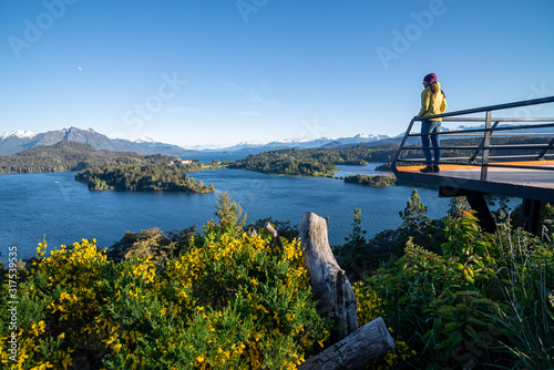 Woman with yellow jacket trekking in Patagonia