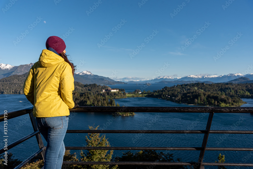 Woman with yellow jacket trekking in Patagonia