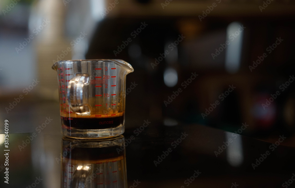 espresso shot placed on a black marble table