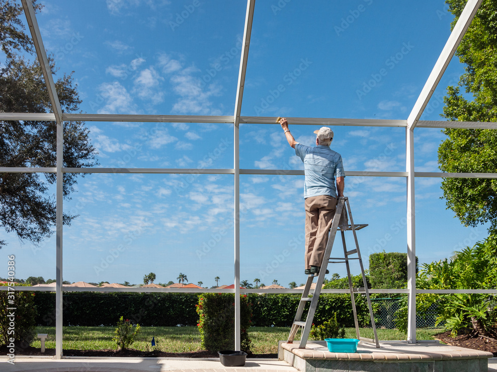 Ταπετσαρία Handyman on ladder cleaning outdoor pool cage enclosure