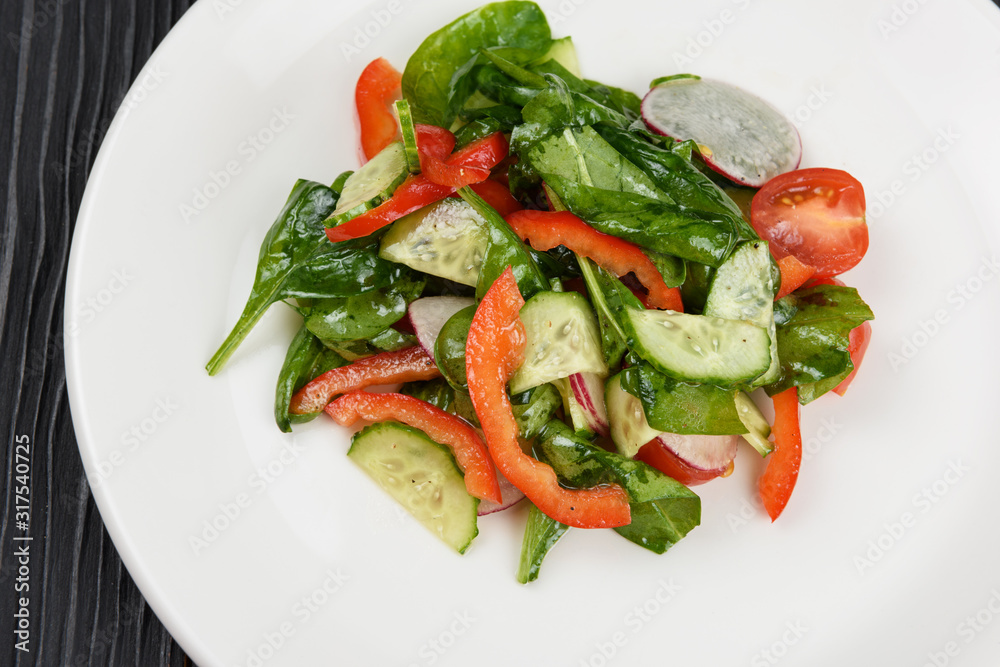 Vegetable vegetarian salad on white plate, closeup