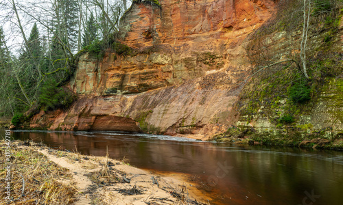 landscape with sandstone cliff on river bank