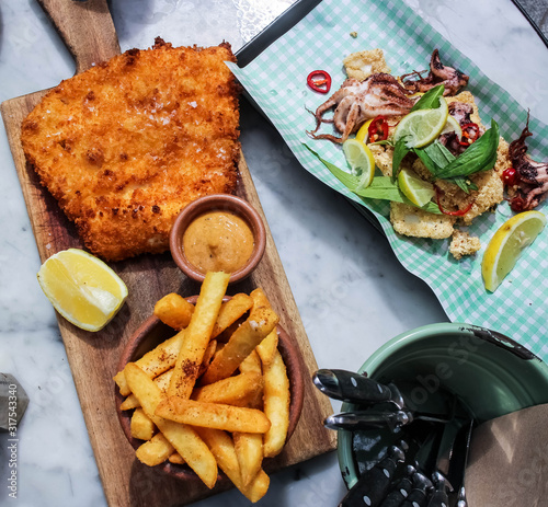 Chicken schnitzel with fries and spicy calamari