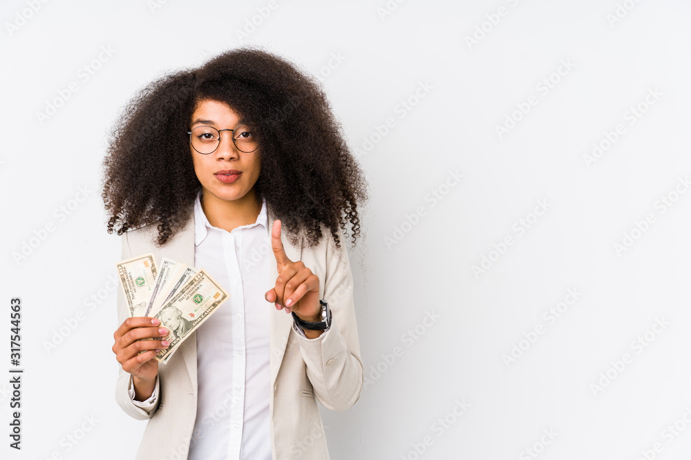 Young afro business woman holding a credit car isolated Young afro business woman holding a credit carshowing number one with finger. Young afro business woman holding a credit car isolated Young afro business woman holding a credit carshowing number one with finger.