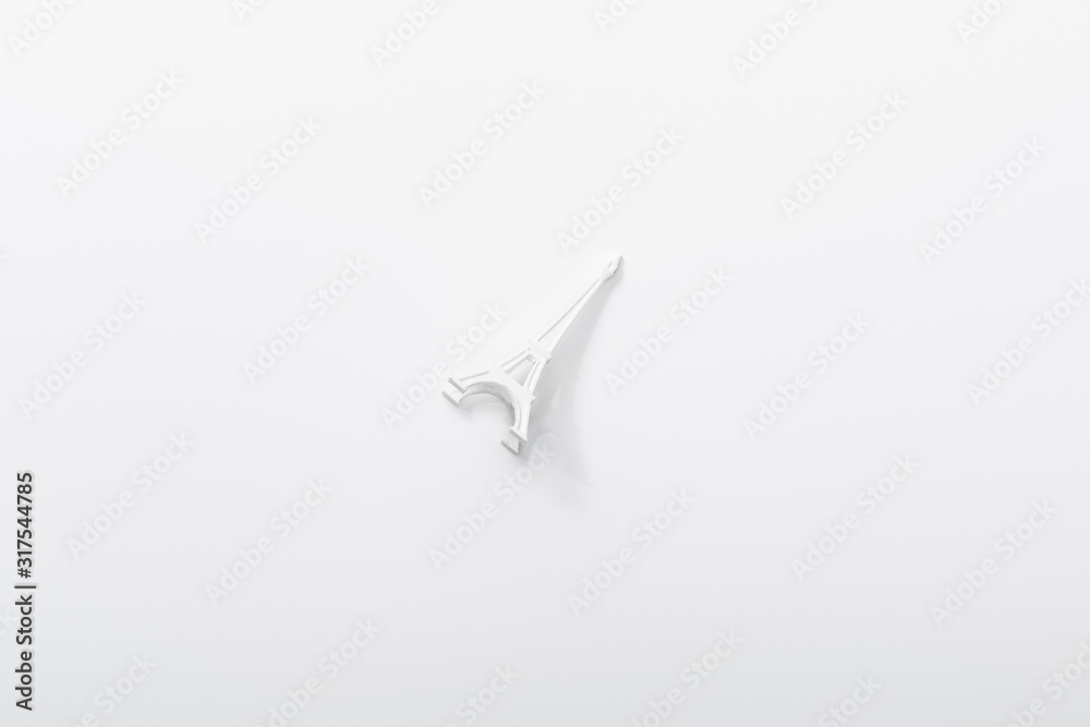 Obraz premium top view of small eiffel tower statuette isolated on white