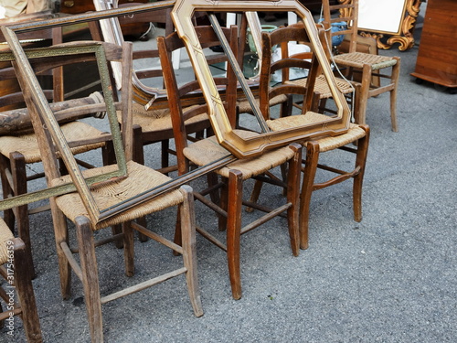 Flea market. Old wooden chairs and frames.