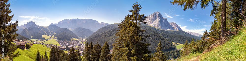 Panoramic view to Selva di Val Gardena and the mountains of the Cir Peaks, Sella, Sassolungo and Sasso Piatto, Dolomite Alps in South Tyrol, Italy