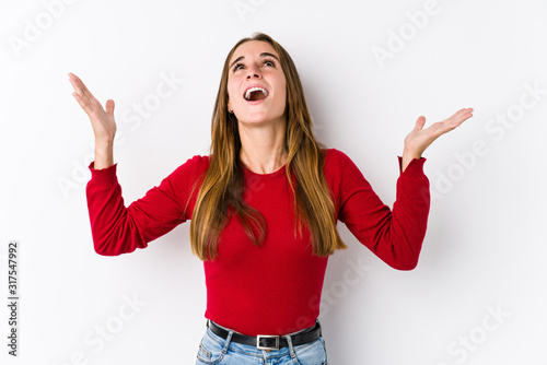 Young caucasian woman posing isolated screaming to the sky, looking up, frustrated.