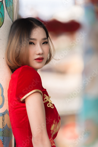 Portrait beautiful asian woman in Cheongsam dress,Thailand people,Happy Chinese new year concept,Happy asian lady in chinese traditional dress