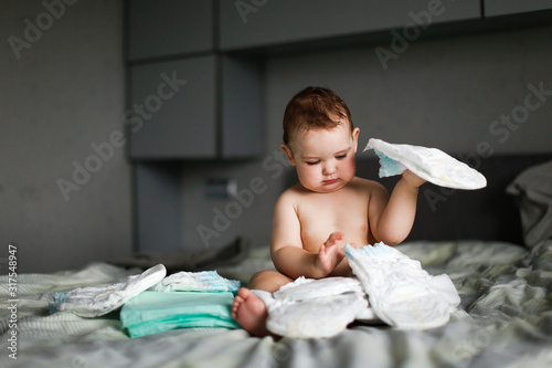 Papier peint Cute chubby baby sitting with disposable diapers