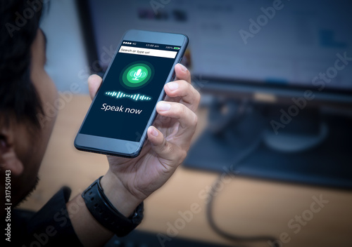 Voice recognition,search technology concept.Close-up of businessman talking on his mobile phone