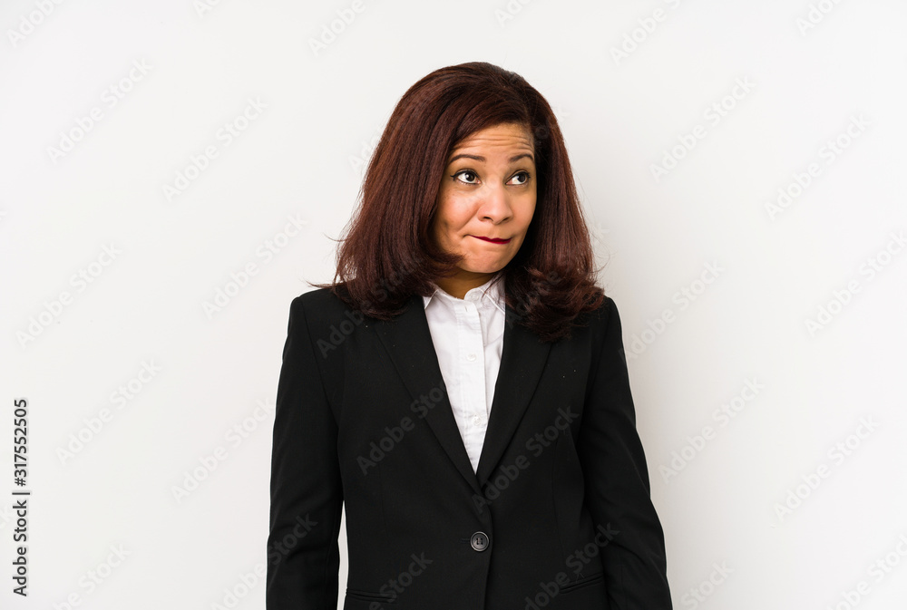 Middle age latin business woman isolated confused, feels doubtful and unsure.