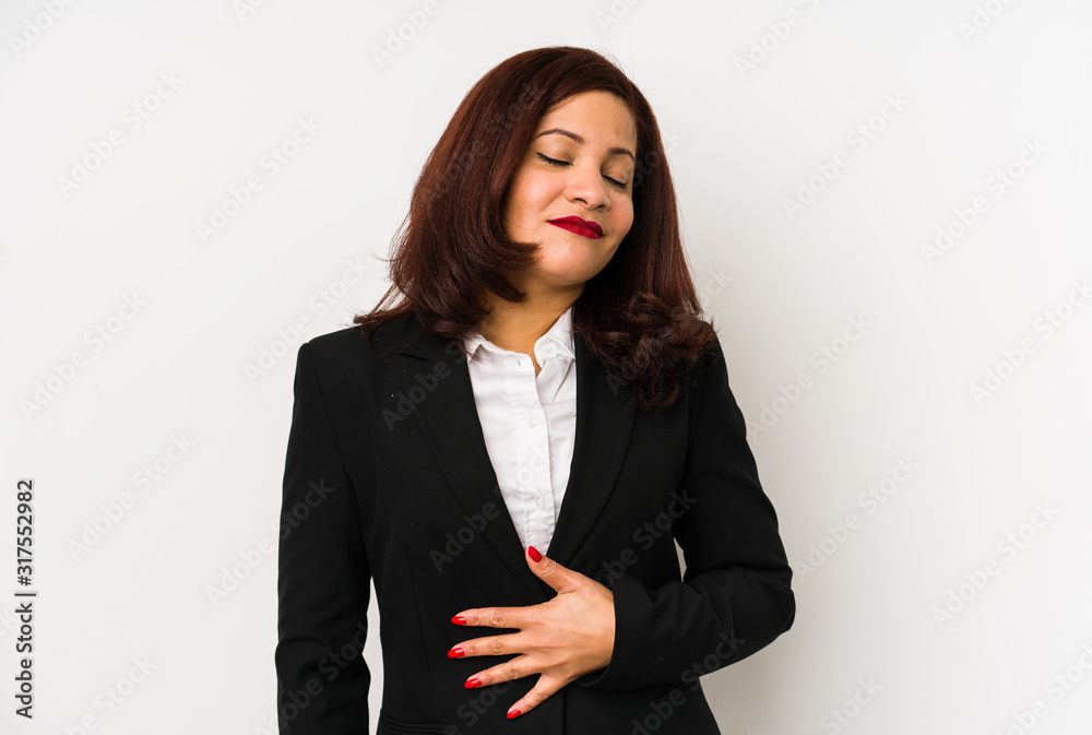 Middle age latin business woman isolated touches tummy, smiles gently, eating and satisfaction concept. Middle age latin business woman isolated touches tummy, smiles gently, eating and satisfaction concept.