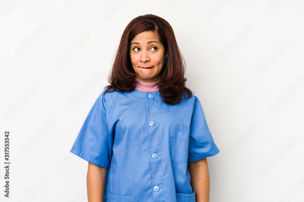 Middle age latin nurse woman isolated çconfused, feels doubtful and unsure. Middle age latin nurse woman isolated çconfused, feels doubtful and unsure.