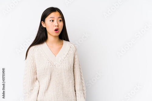 Young chinese woman isolated being shocked because of something she has seen.