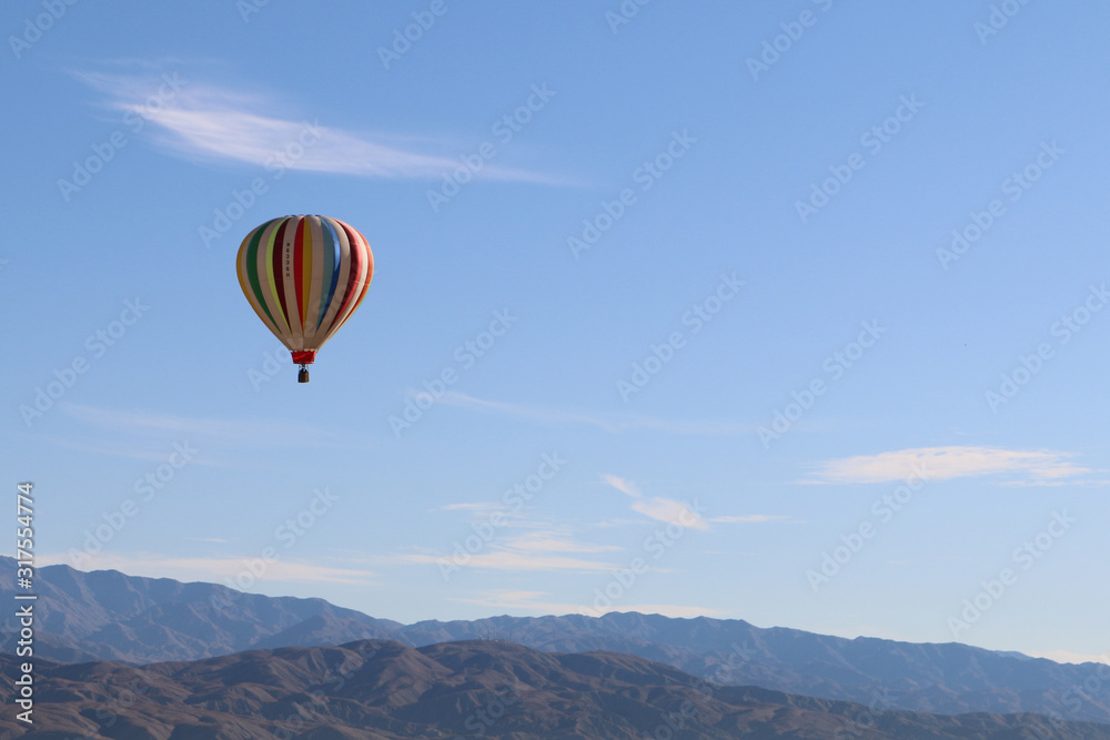 hot air balloon sky over mountains desert