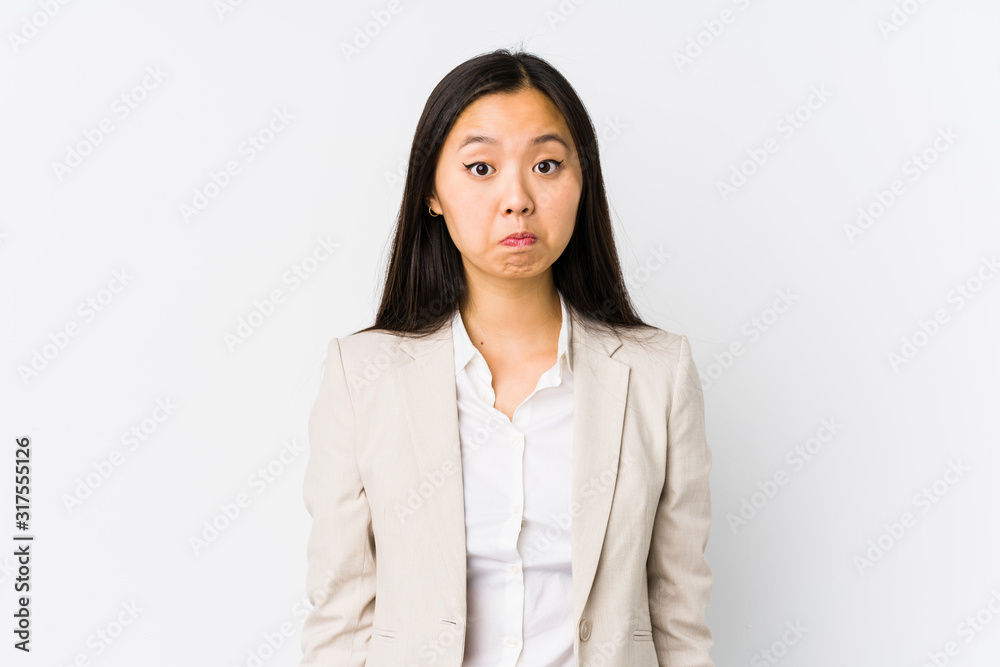 Young chinese business woman isolated shrugs shoulders and open eyes confused. Young chinese business woman isolated shrugs shoulders and open eyes confused.