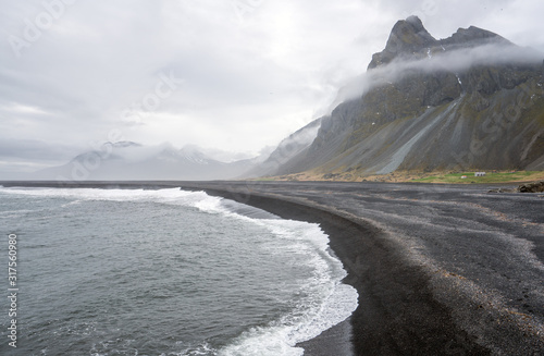 Hvalnes beach and Eystrahorn mountains on the south coast of Iceland during foggy weather. Travel and explorer concept.