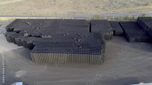 A lot of  black plastic boxes on the production storage fruit photo