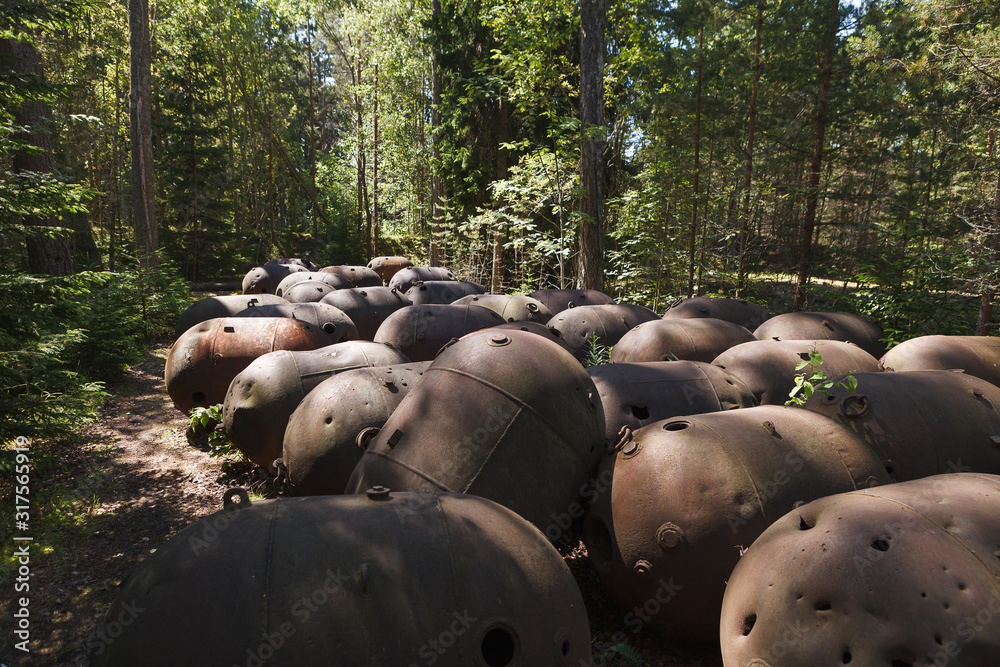 Old WWII underwater mines in the former USSR island-based military base. Naissaar, Estonia. Mines rusted from the weather outdoor Old WWII underwater mines in the former USSR island-based military base. Naissaar, Estonia. Mines rusted from the weather outdoor