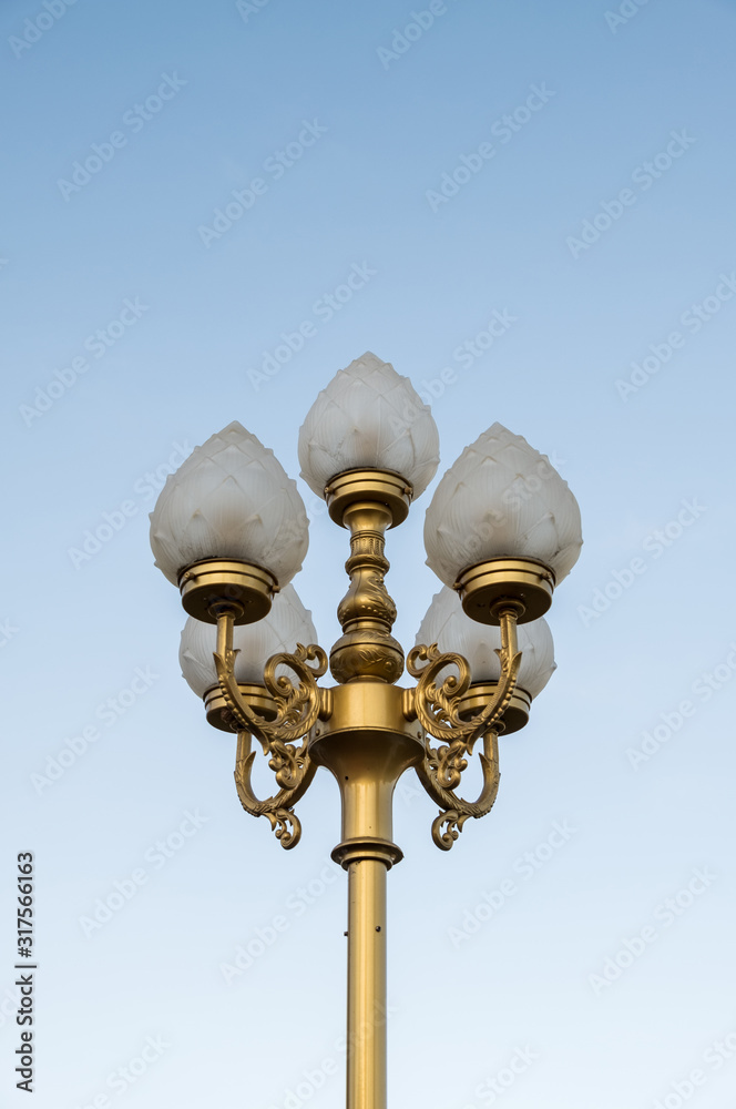Electrical lamp with the traditional Thai pattern on the golden pole. Electrical lamp with the traditional Thai pattern on the golden pole.