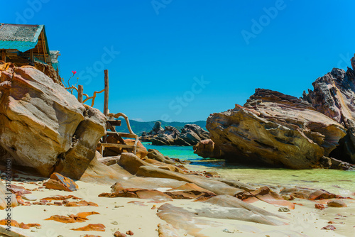 Scenic cliffs on a sandy tropical Thai beach.