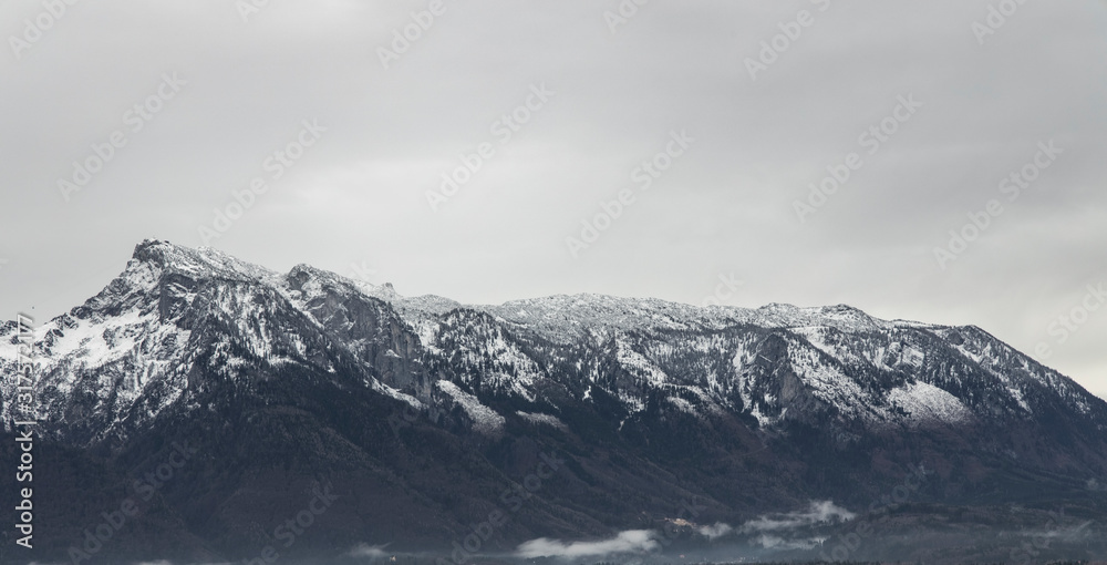 panoramic view snowy mountain ridge landscape moody background winter time snowy peak and gray sky wallpaper nature with empty copy space for your text here