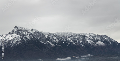 panoramic view snowy mountain ridge landscape moody background winter time snowy peak and gray sky wallpaper nature with empty copy space for your text here © Артём Князь