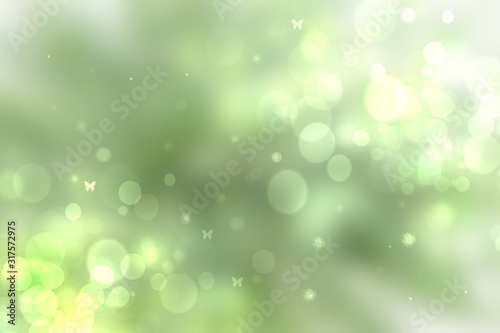 Abstract bright spring or summer landscape texture with natural green bokeh lights and yellow circular lights with sunshine, sun rays and butterflies. Beautiful autumn background with copy space.