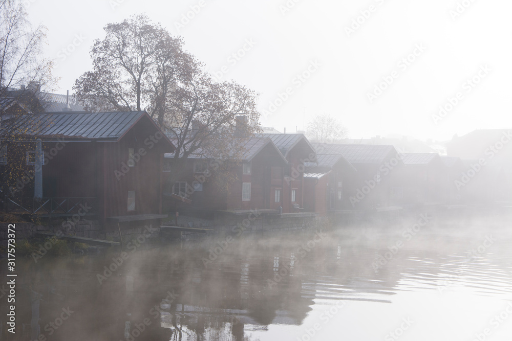 Foggy view of Porvoo city and Porvoonjoki river in early morning, old wooden houses, Porvoo, Finland