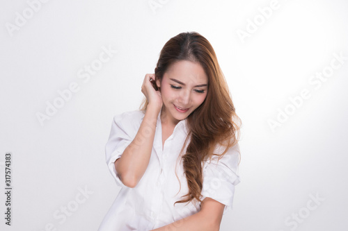 Asian woman portrait with perfect skin and wearing a white shirt in profile isolated on gray background.