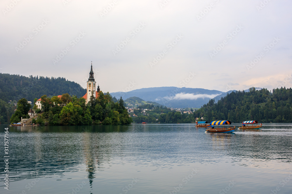 Tourists in Pletna boat at lake Bled, Slovenia