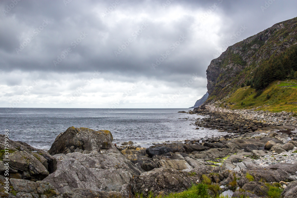  mountains and rocks by the sea on a rainy day in Norway