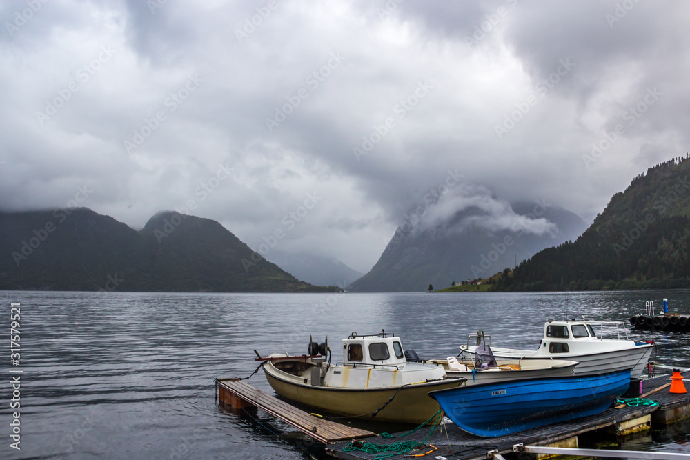  mountains and rocks by the sea on a rainy day in Norway