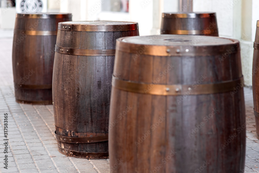 brown wooden barrel on outdoor on stone gray tile, bar decorations close up nobody. brown wooden barrel on outdoor on stone gray tile, bar decorations close up nobody.