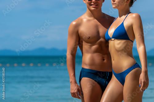 Young sports couple on Tropical Beach. Fashion Photo Shoot.