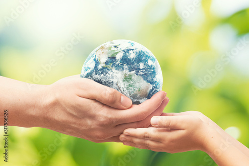 Earth globe in hands. World environment day. Elements of this image furnished by NASA. photo