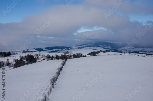 Snowy road to the near village  Dolni Hedec  Czech Republic.
